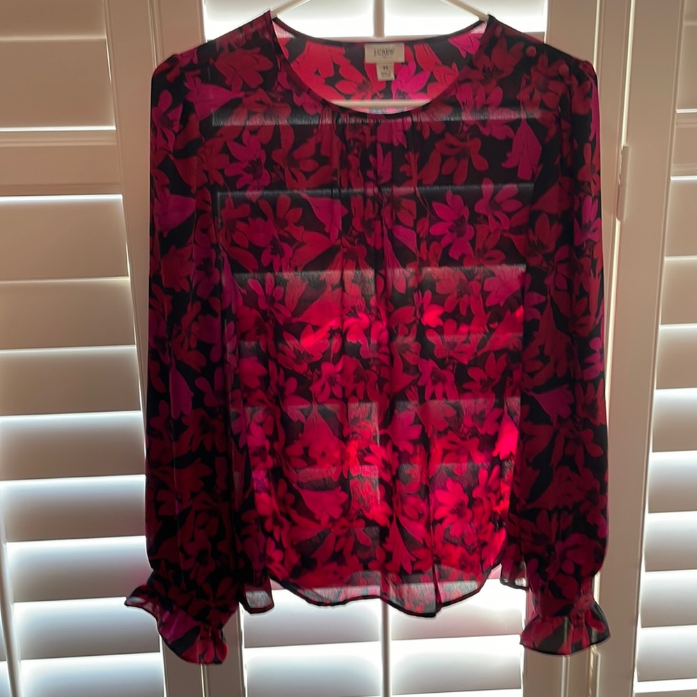 Black floral blouse with ruffled wrist and covered buttons